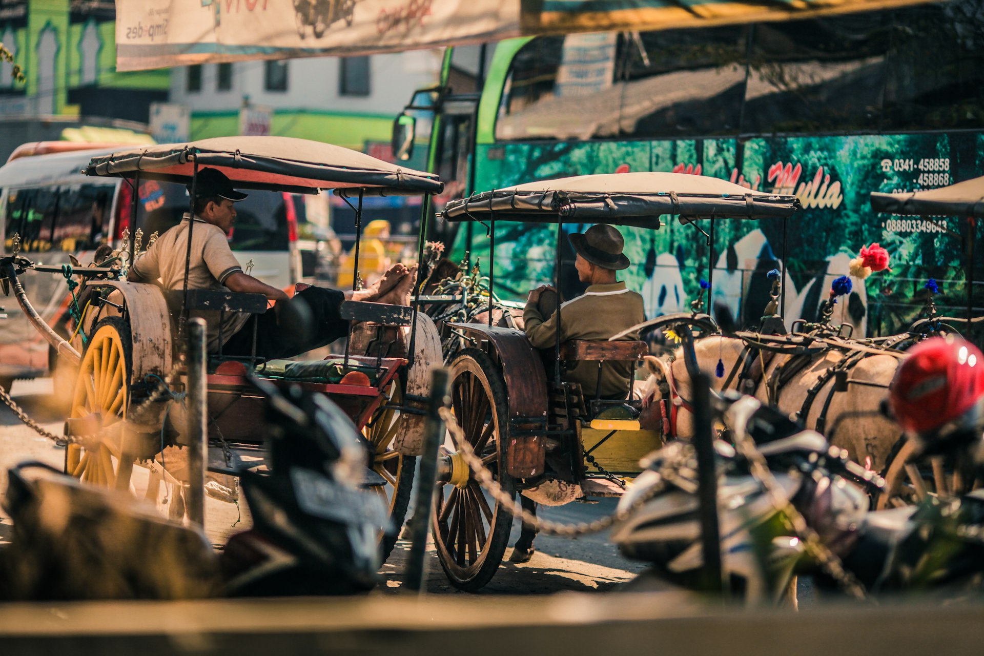 people riding on brown and black wooden cart during daytime